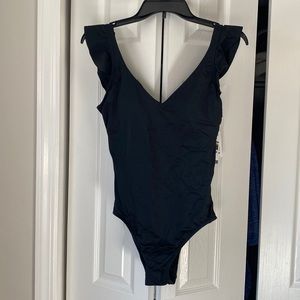 Black one piece flutter shoulder bathing suit. Size medium.